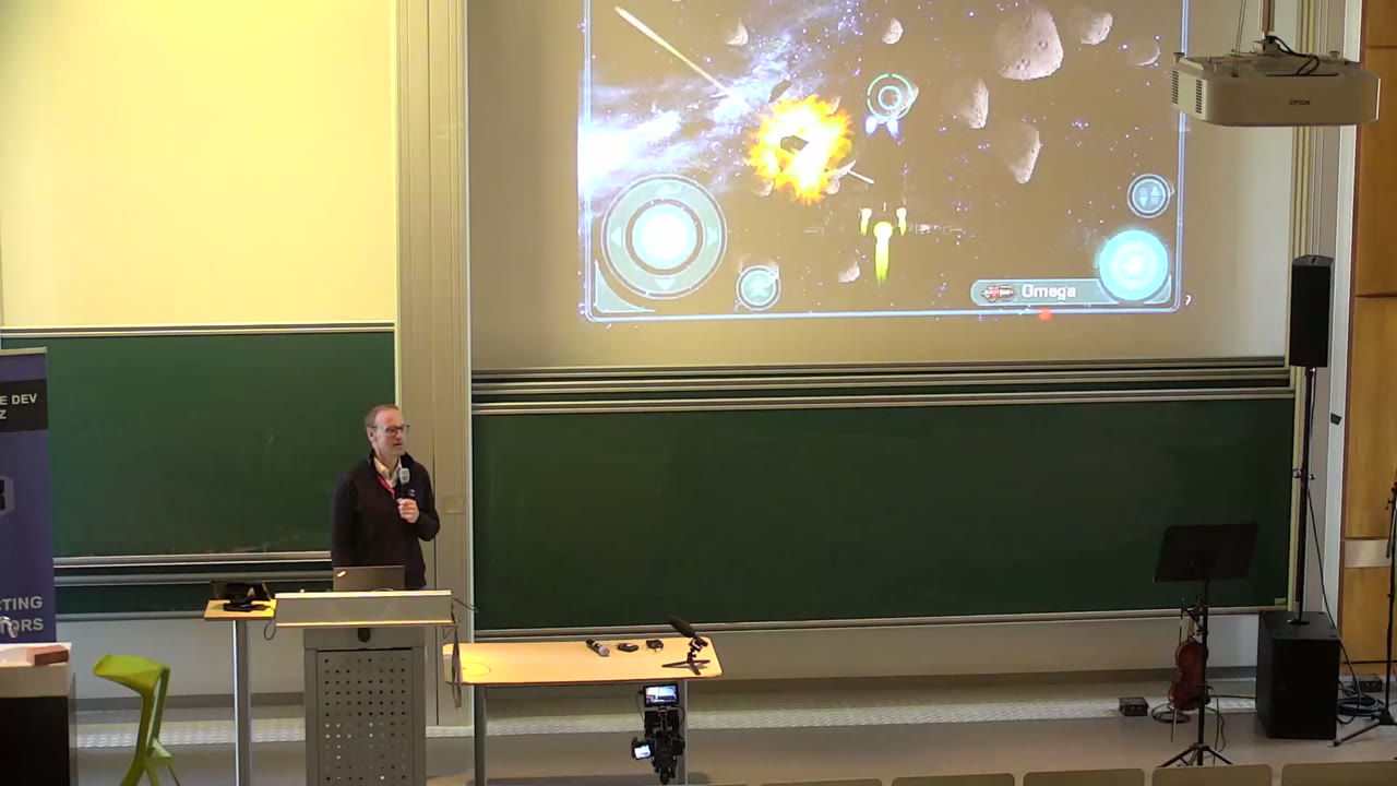 Talk on stage at Game Dev Days Graz 2025, from the TUbe recording