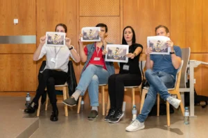 Jury members holding up voting cards at Game Dev Days Graz 2018